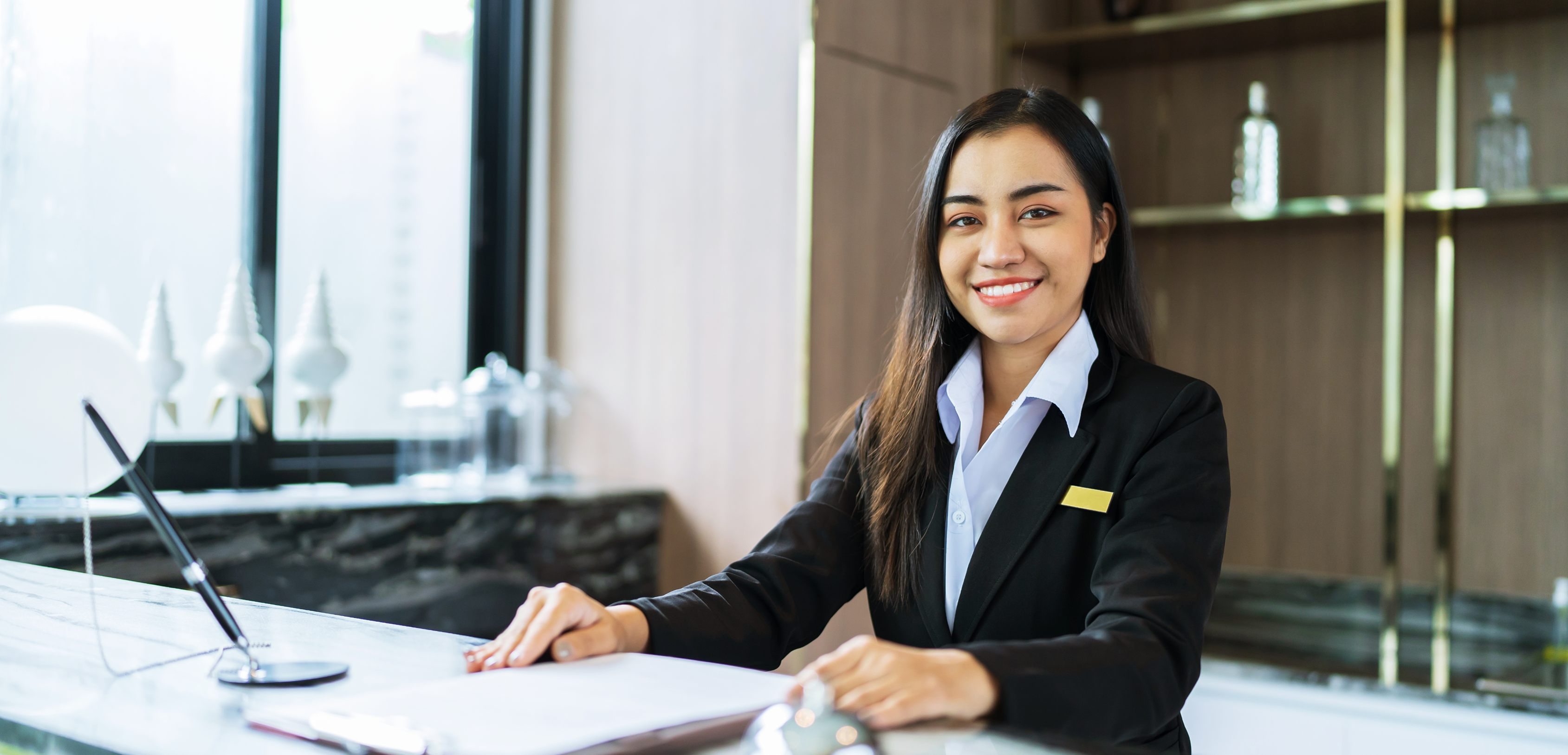 Hotel receptionist welcoming guests